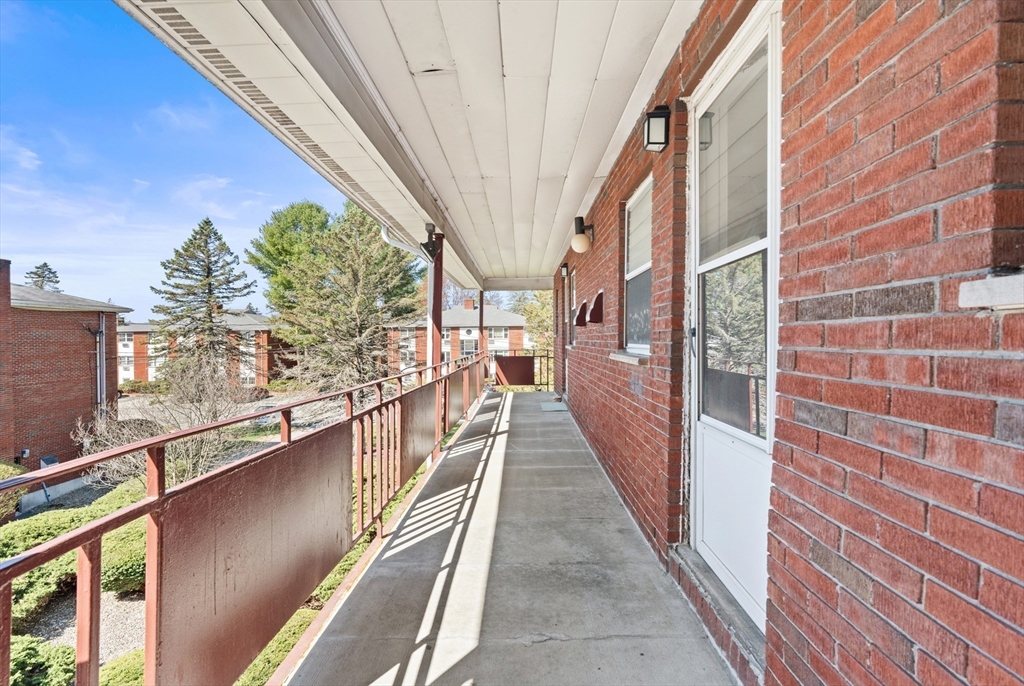 2 Colonial Drive, Unit E25 Andover, MA 01810 - Photo 15 of 17 a view of a balcony with wooden floor and stairs
