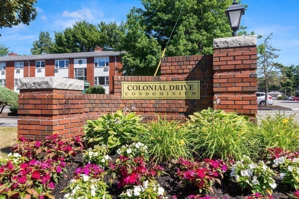 2 Colonial Drive, Unit E25 Andover, MA 01810 - Photo 2 of 17 a view of a sign board with buildings in the background