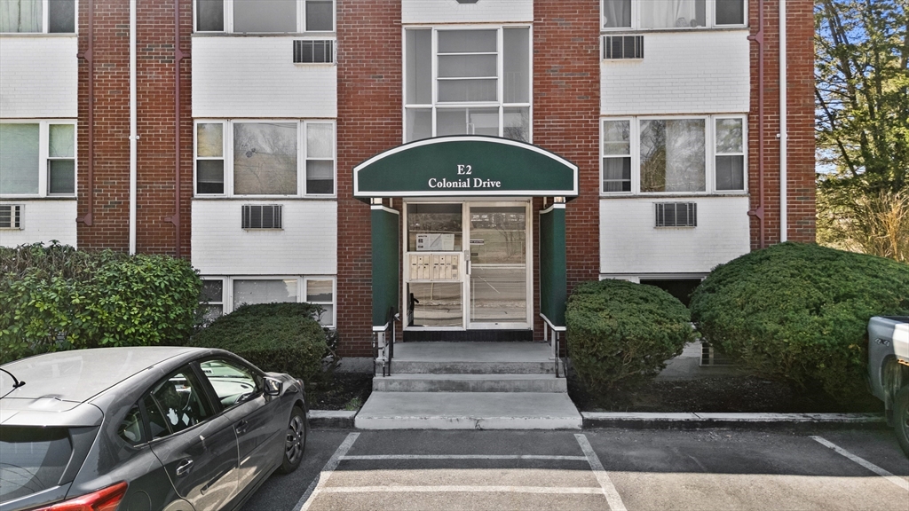 2 Colonial Drive, Unit E25 Andover, MA 01810 - Photo 4 of 17 a front view of a house with windows