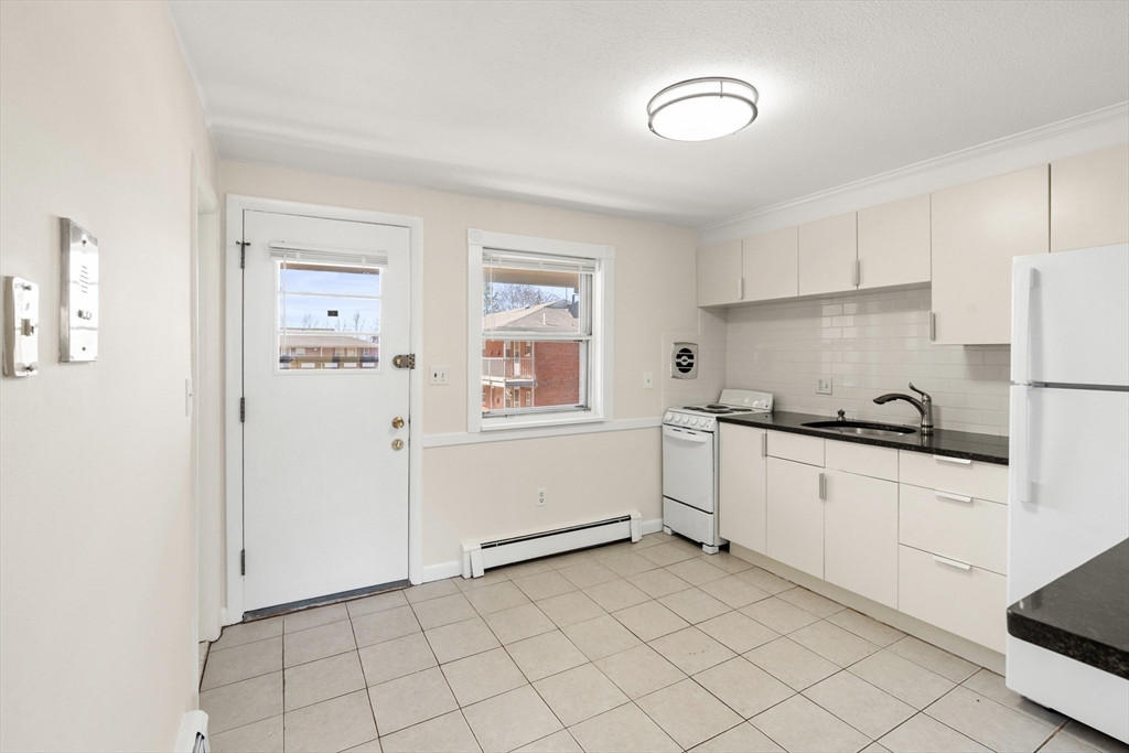 2 Colonial Drive, Unit E25 Andover, MA 01810 - Photo 7 of 17 a kitchen with cabinets and window