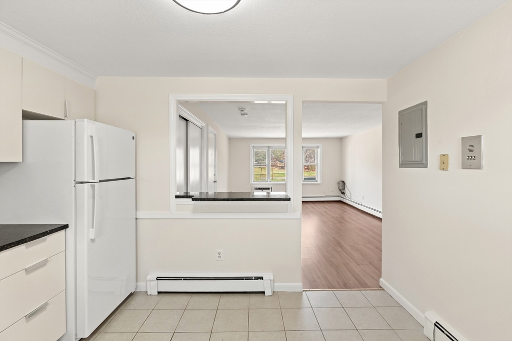 2 Colonial Drive, Unit E25 Andover, MA 01810 - Photo 10 of 17 a view of a refrigerator in kitchen and white cabinets