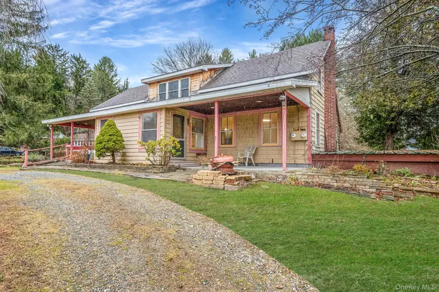front view of a house with yard porch and sitting area