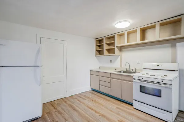 a kitchen with stainless steel appliances granite countertop a stove and a white cabinets