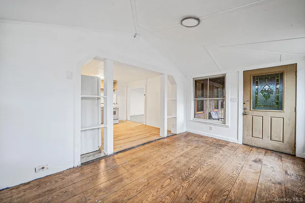 a view of empty room with wooden floor and cabinet