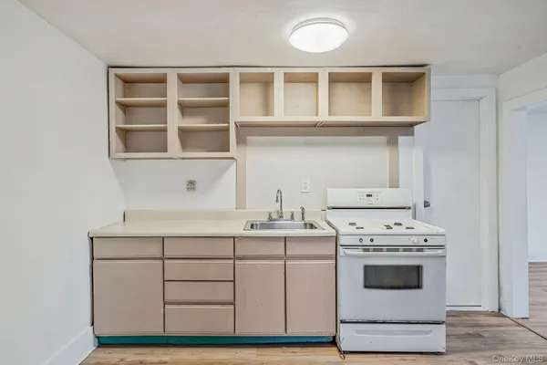 a kitchen with a stove oven and white cabinets