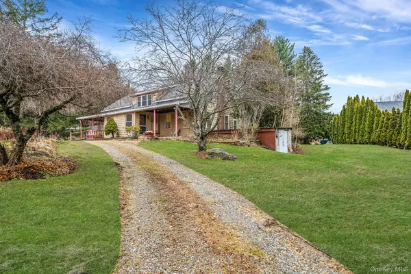 a front view of house with yard and green space