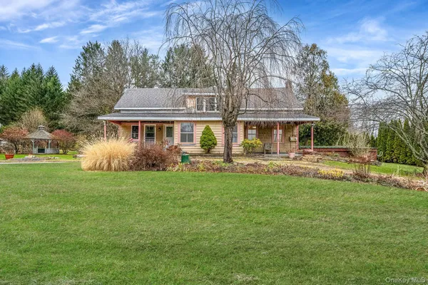a front view of a house with a yard table and chairs