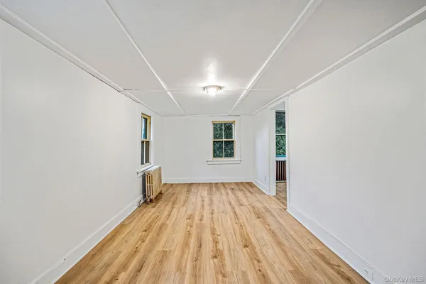 a view of a room with wooden floor and outdoor space