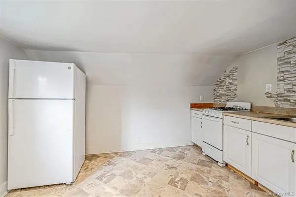 a room with a refrigerator and cabinets