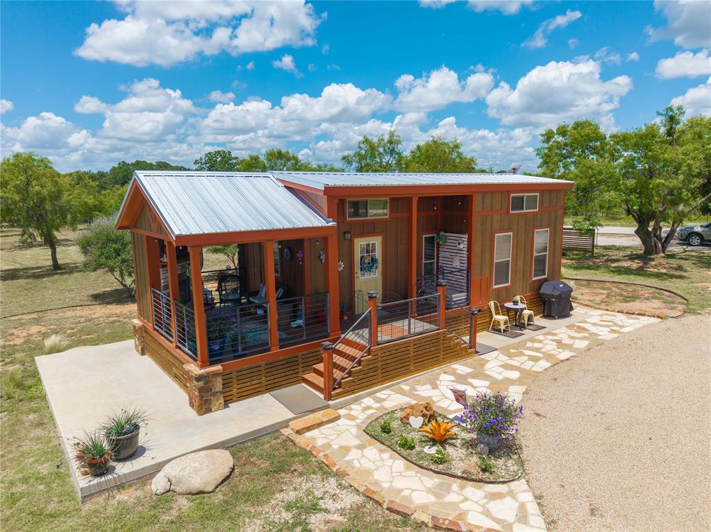 1010 Fm 583 Street West Rising Star, TX 76471 - Photo 33 of 40 a view of a house with floor to ceiling windows and yard