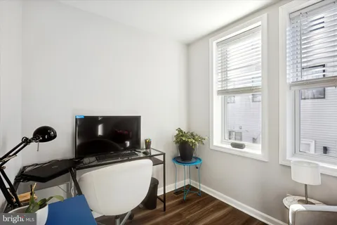 a view of a workspace with furniture and a window