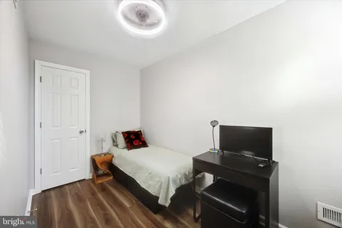 a bedroom with a bed and flat screen tv