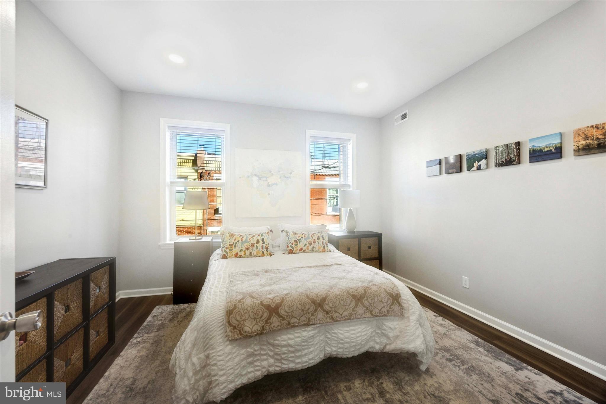 720 Tree Street Philadelphia, PA 19148 - Photo 20 of 26 a bedroom with a bed and wooden floor