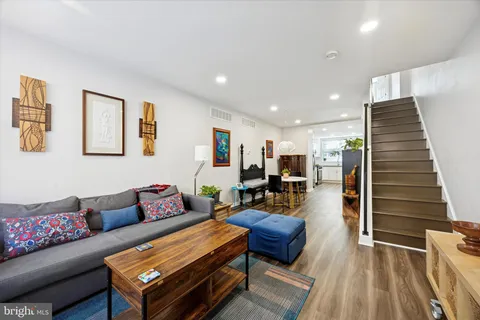 a living room with furniture and wooden floor