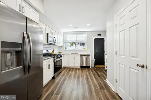 a kitchen with refrigerator a sink and cabinets