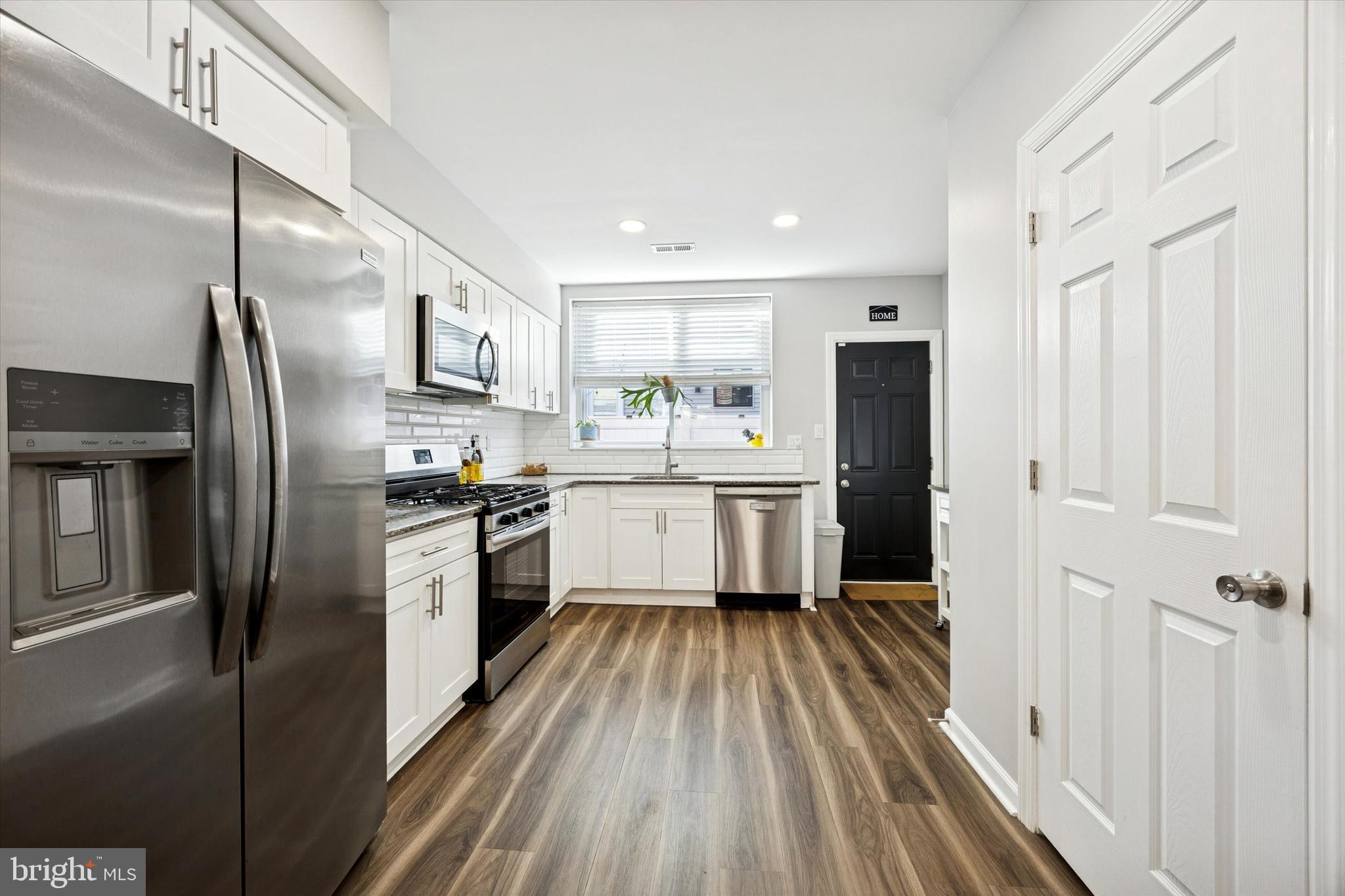 720 Tree Street Philadelphia, PA 19148 - Photo 9 of 26 a kitchen with refrigerator a sink and cabinets