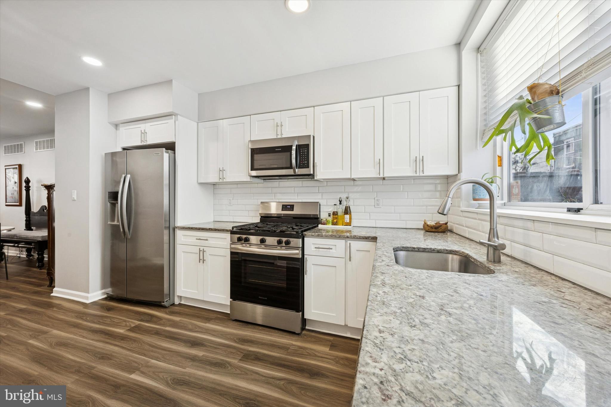 720 Tree Street Philadelphia, PA 19148 - Photo 10 of 26 a kitchen with granite countertop a refrigerator stove and microwave