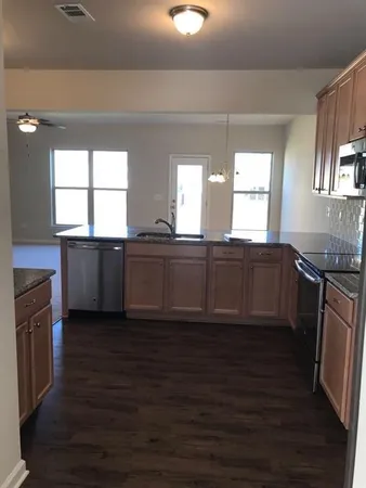 a view of a kitchen counter space and windows