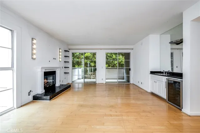 a view of an empty room with a fireplace and a window