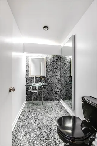 a view of a hallway to a room with windows