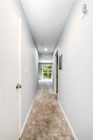 an empty room with closet and a window