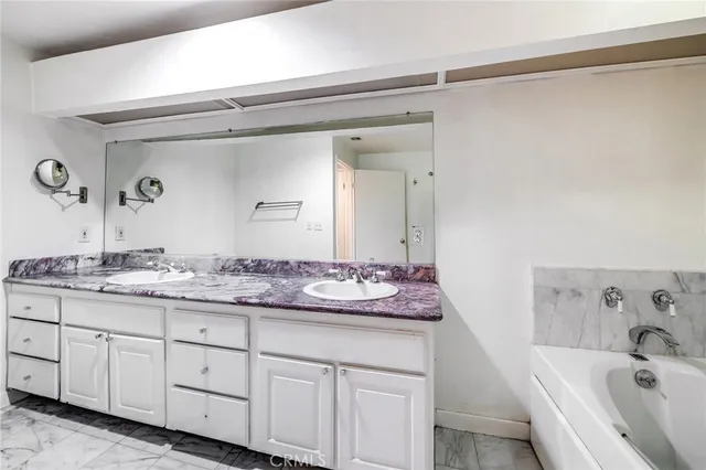 a bathroom with a bathtub and a window