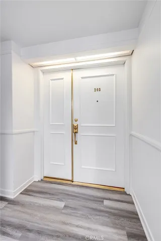 a view of hallway with a large mirror and a rug