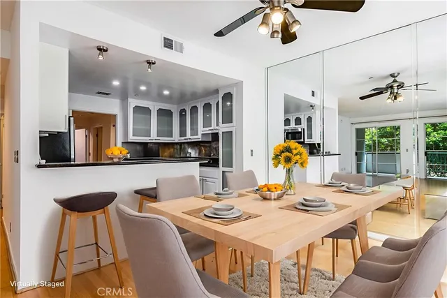 a kitchen with stainless steel appliances kitchen island granite countertop a sink and cabinets