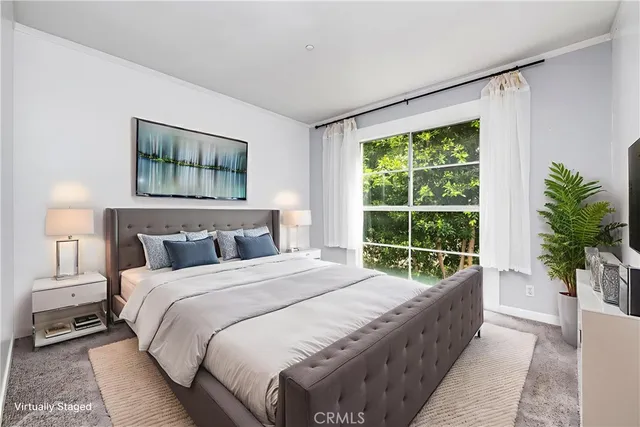 a bed sitting in a bedroom next to a window