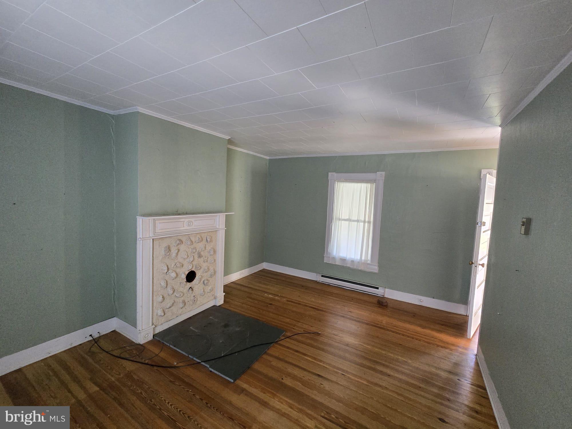 8034 Bozman Neavitt Road St. Michaels, MD 21663 - Photo 15 of 22 wooden floor in an empty room with a window