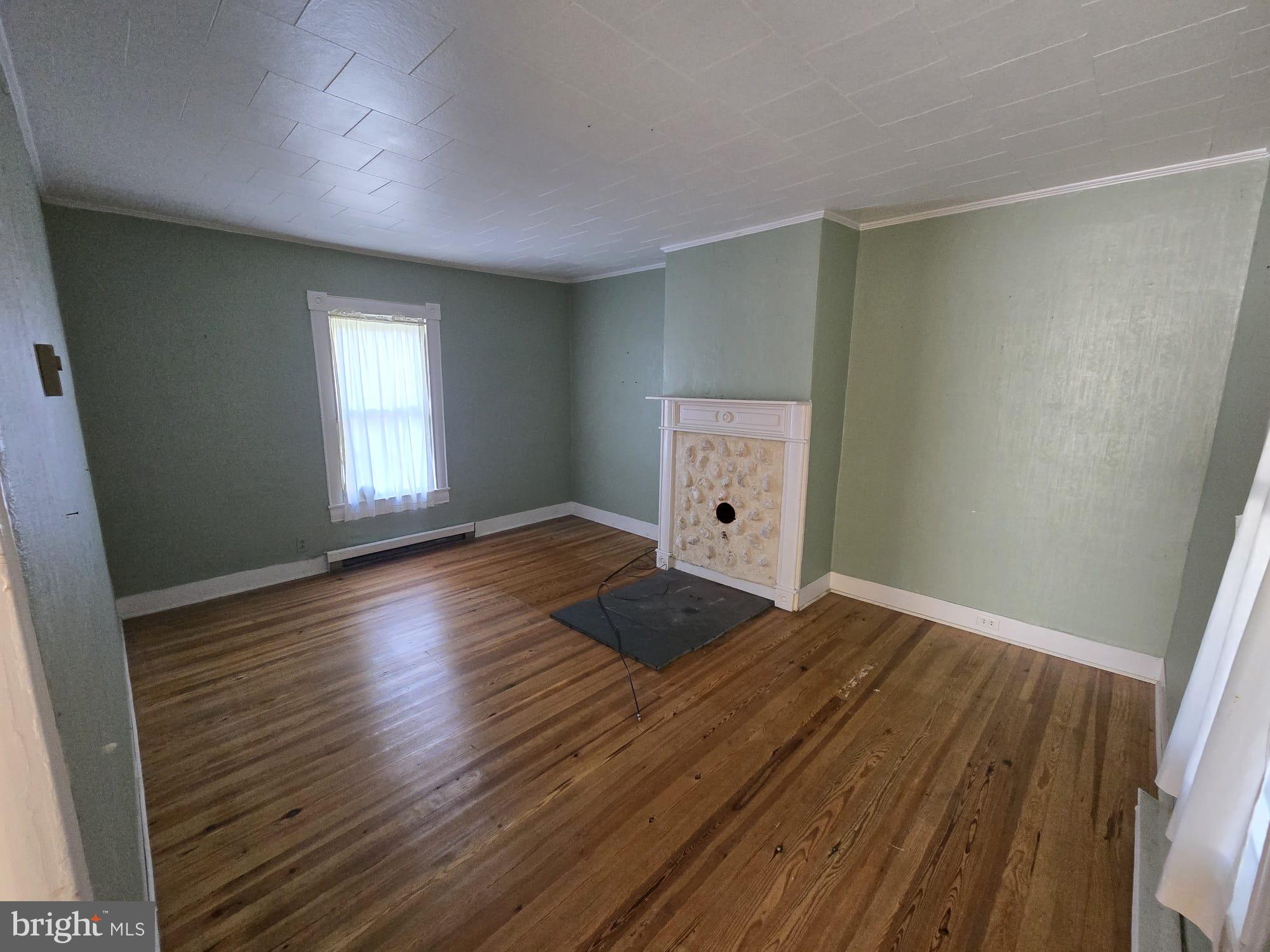 8034 Bozman Neavitt Road St. Michaels, MD 21663 - Photo 16 of 22 an empty room with wooden floor and windows