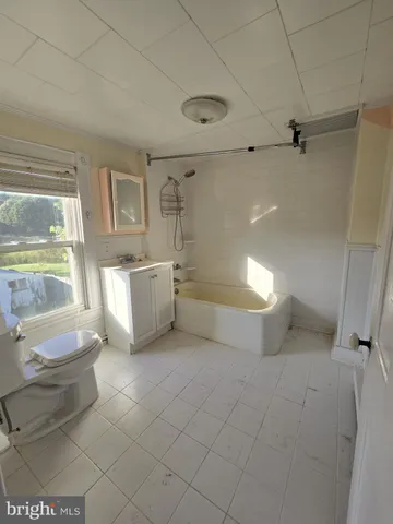 a view of a hallway with wooden floor and stairs