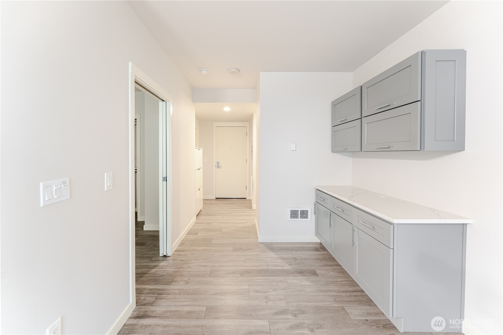 76 Cedar Street, Unit 303 Seattle, WA 98121 - Photo 12 of 29 a view of a hallway with wooden floor