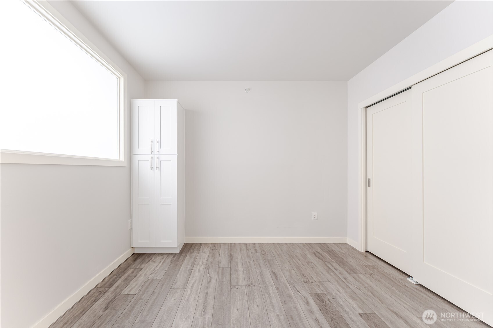 76 Cedar Street, Unit 303 Seattle, WA 98121 - Photo 14 of 29 a view of an empty room with wooden floor