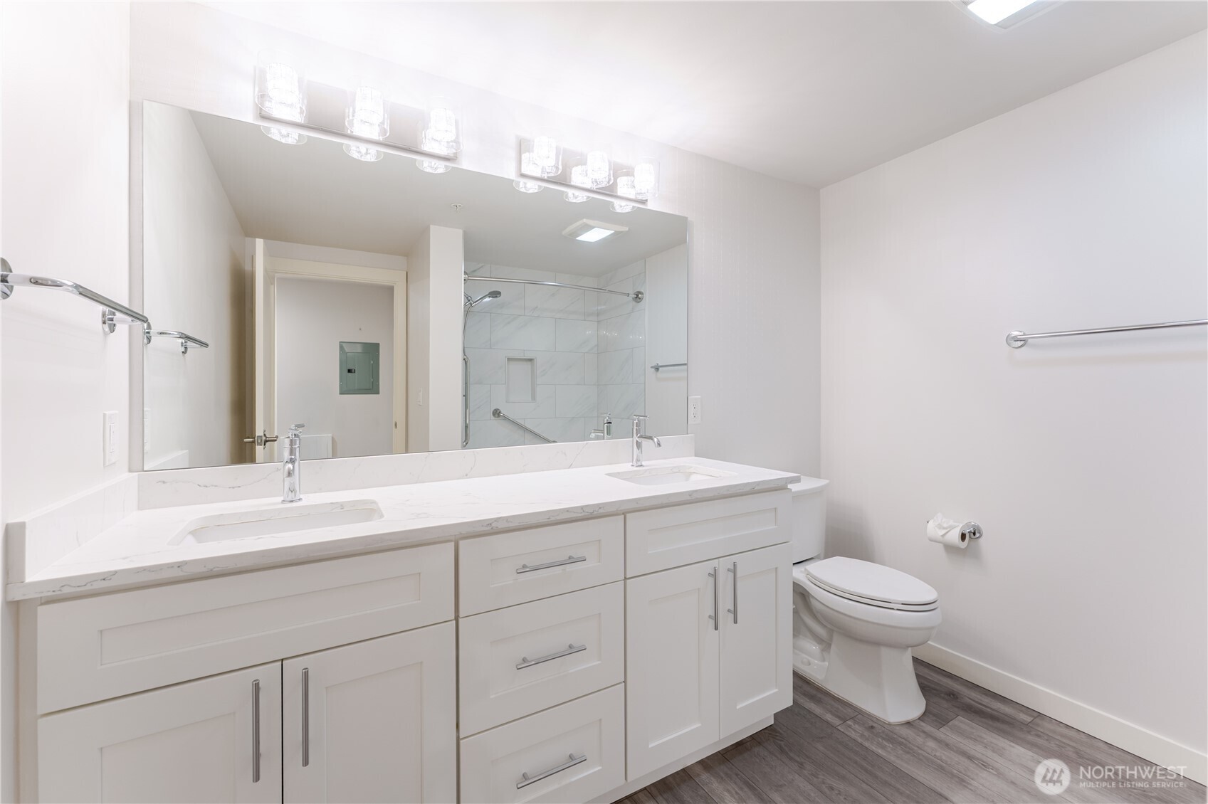 76 Cedar Street, Unit 303 Seattle, WA 98121 - Photo 15 of 29 a bathroom with a toilet a sink and mirror