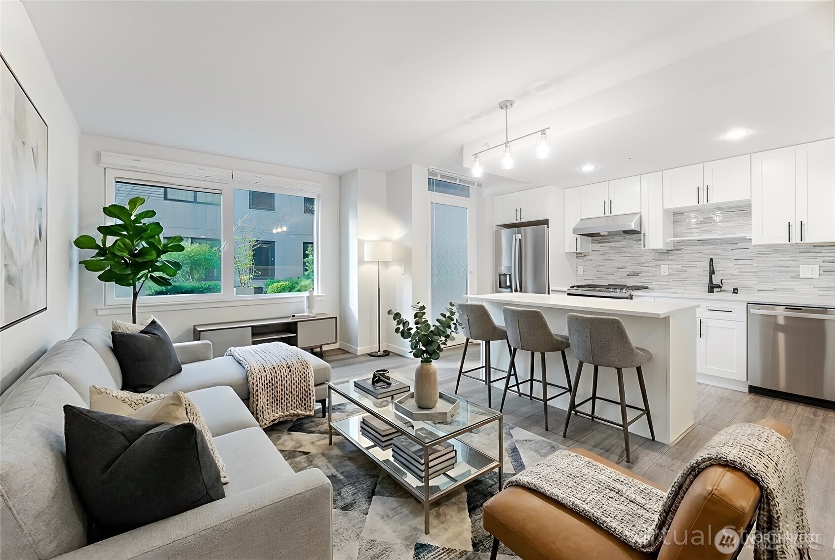 76 Cedar Street, Unit 303 Seattle, WA 98121 - Photo 2 of 29 a living room with furniture kitchen and a chandelier