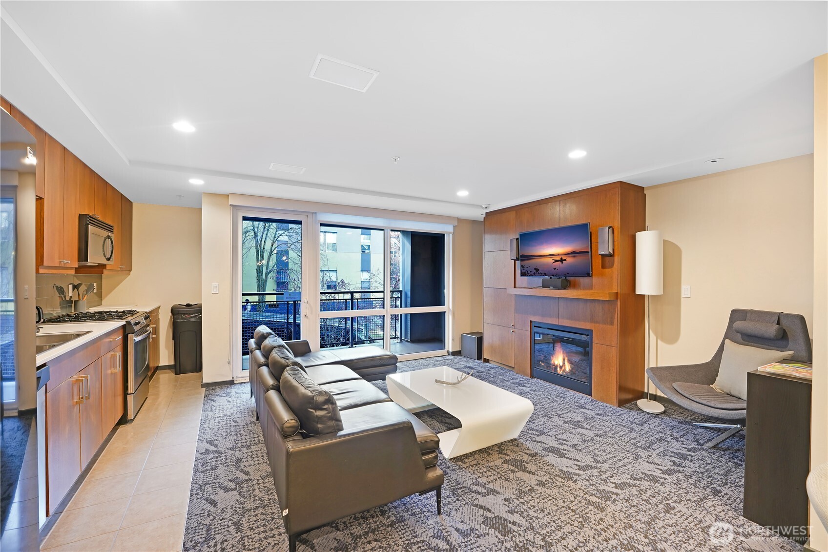 76 Cedar Street, Unit 303 Seattle, WA 98121 - Photo 22 of 29 a living room with fireplace furniture and a flat screen tv