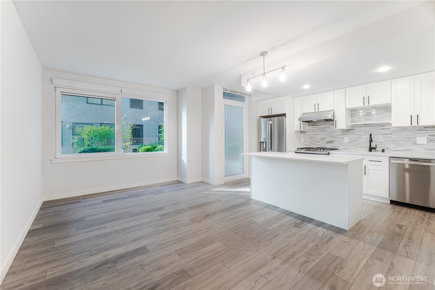 76 Cedar Street, Unit 303 Seattle, WA 98121 - Photo 7 of 29 a view of kitchen with wooden floor and window