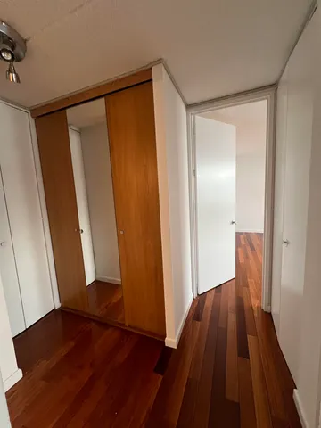 a view of hallway with wooden floor