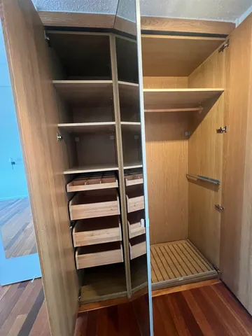 a view of walk in closet with empty racks
