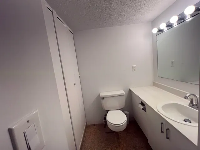 a white toilet sitting next to a bathroom sink
