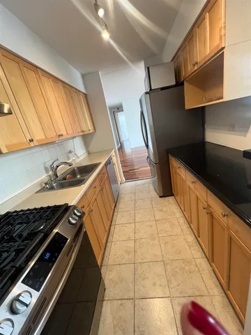a kitchen with stainless steel appliances a sink stove and cabinets