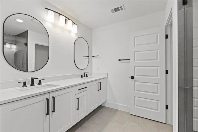 a bathroom with a shower and mirror