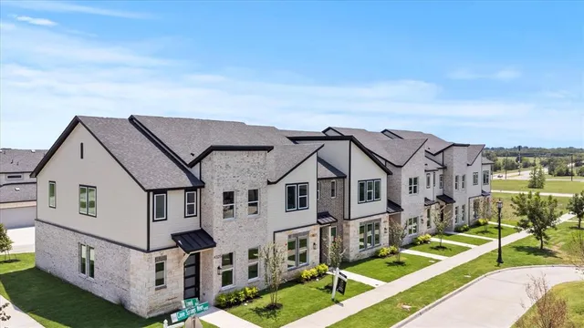a view of multiple houses with a big yard