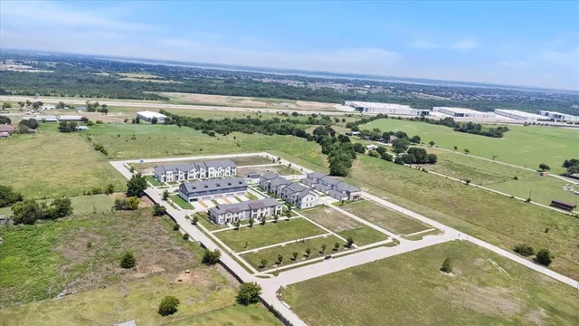 an aerial view of a pool with lawn chairs