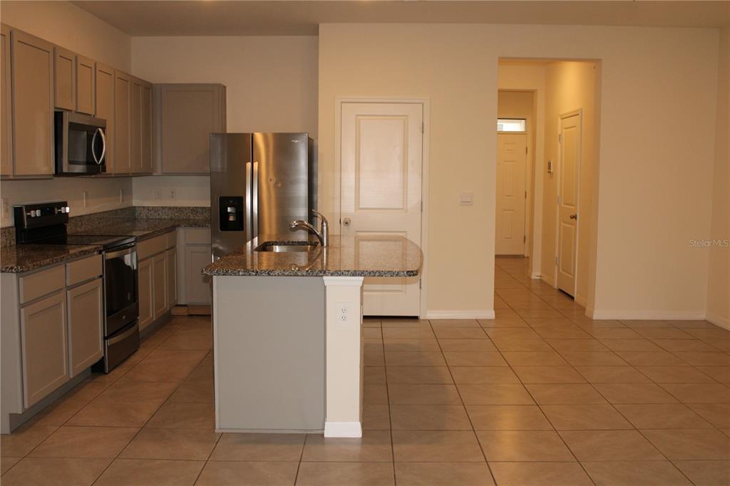 17567 Crescent Moon Loop Bradenton, FL 34211 - Photo 13 of 51 a kitchen with a sink a counter top space and stainless steel appliances