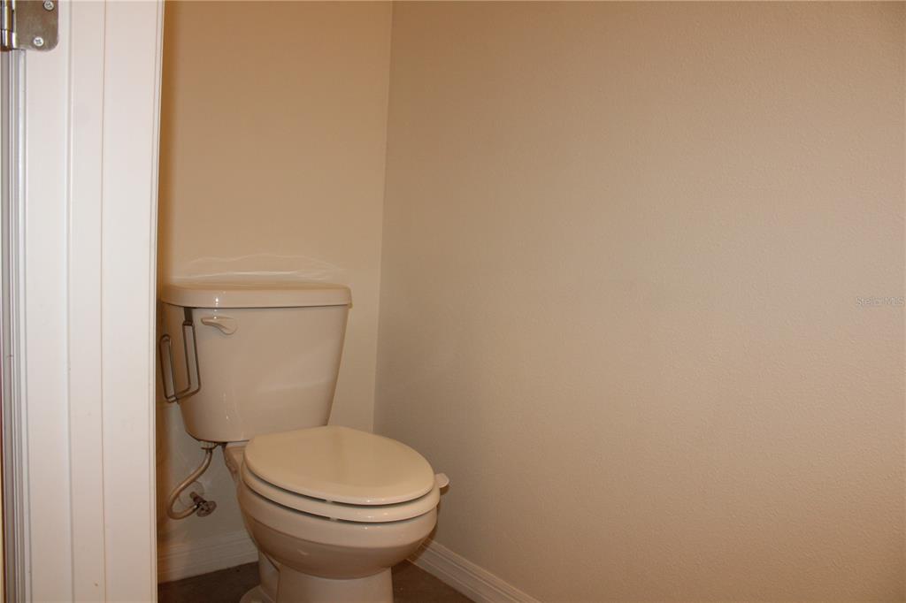 17567 Crescent Moon Loop Bradenton, FL 34211 - Photo 15 of 51 a white toilet sitting next to a white wall