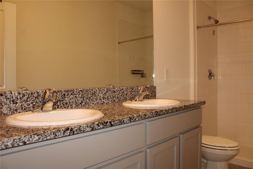 17567 Crescent Moon Loop Bradenton, FL 34211 - Photo 22 of 51 a bathroom with a granite countertop sink and a mirror