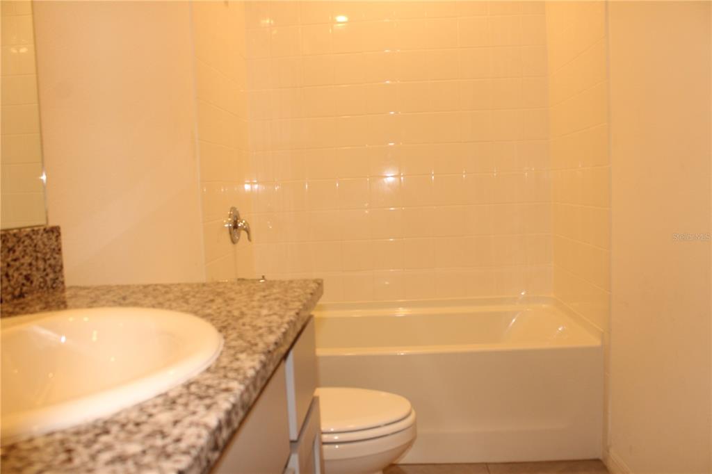 17567 Crescent Moon Loop Bradenton, FL 34211 - Photo 30 of 51 a bathroom with a granite countertop sink and a mirror