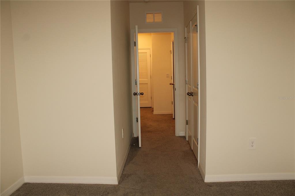 17567 Crescent Moon Loop Bradenton, FL 34211 - Photo 34 of 51 a view of a hallway with a wooden door